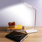 Smart LED desk lamp with adjustable brightness and wireless charging on a desk
