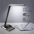Smart LED desk lamp with adjustable brightness and built-in wireless charging pad on a desk