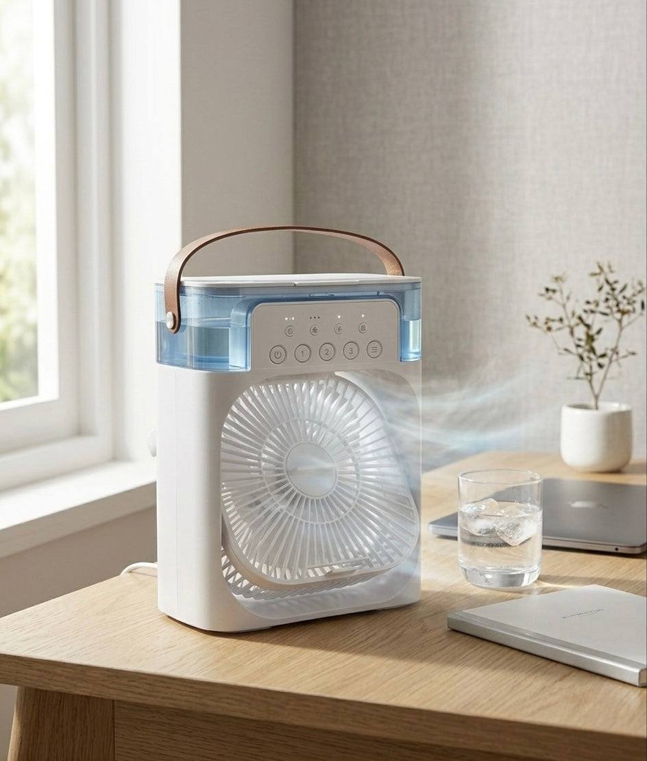 Portable fan on a wooden table with a glass of water and a plant in the background.