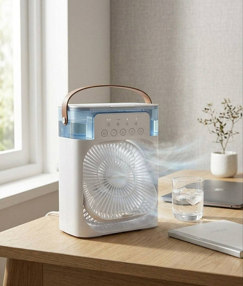 Portable fan on a wooden table with a glass of water and a plant in the background.