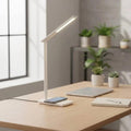Smart LED Desk Lamp with adjustable lighting and wireless charging pad on a modern desk