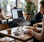 Adjustable Aluminium Laptop Stand in silver metal, supporting a laptop on a height-adjustable arm with a round base