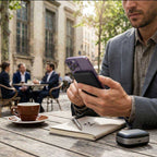 Magnetic Wireless Power Bank in black with a slim rounded case attached to a purple smartphone for wireless charging