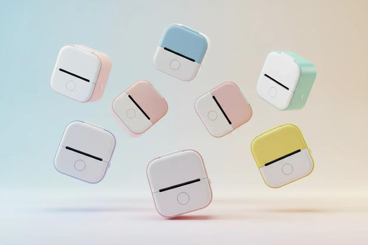 Portable Mini Thermal Label Printers in various colors on a gradient background